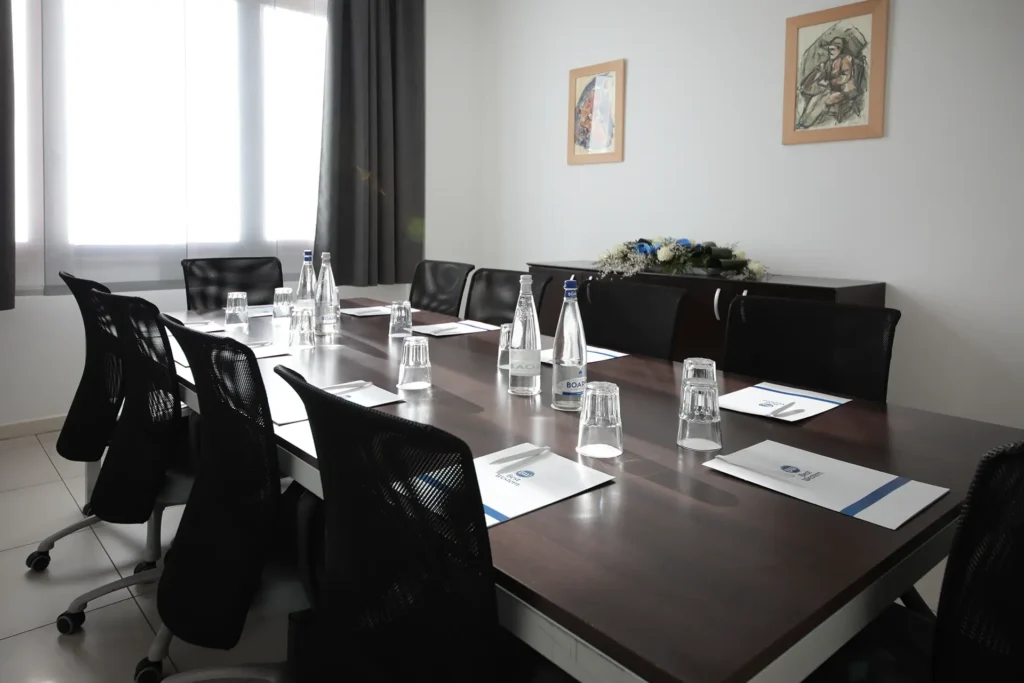 In the image a meeting room with a single table arrangement